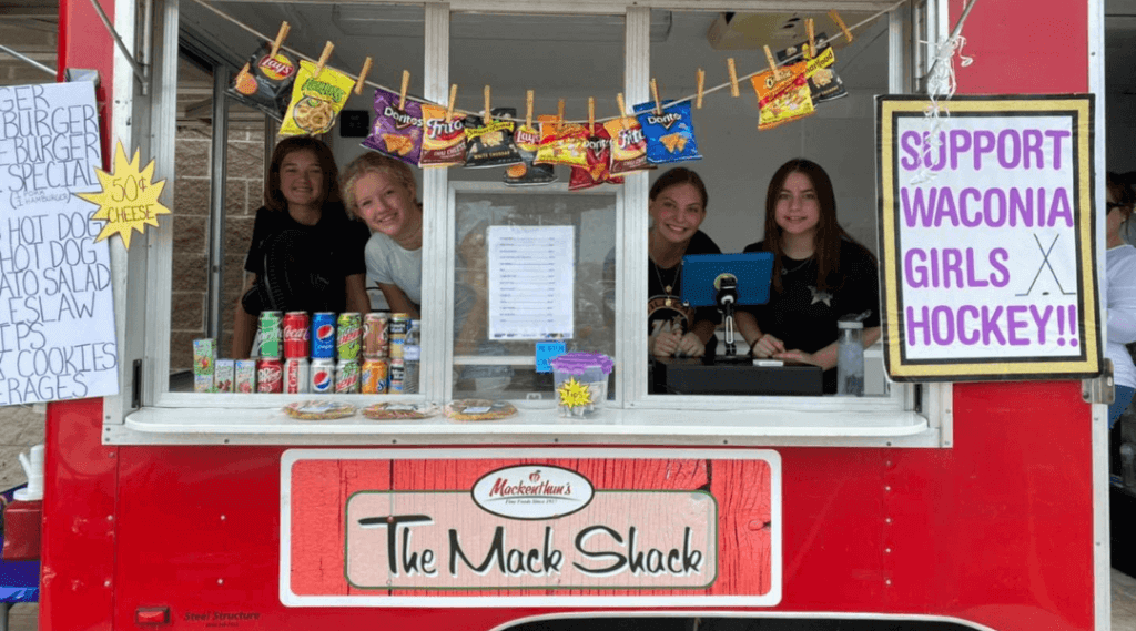 Waconia Girls Hockey volunteering at the Mack Shack to help fundraise for their team.