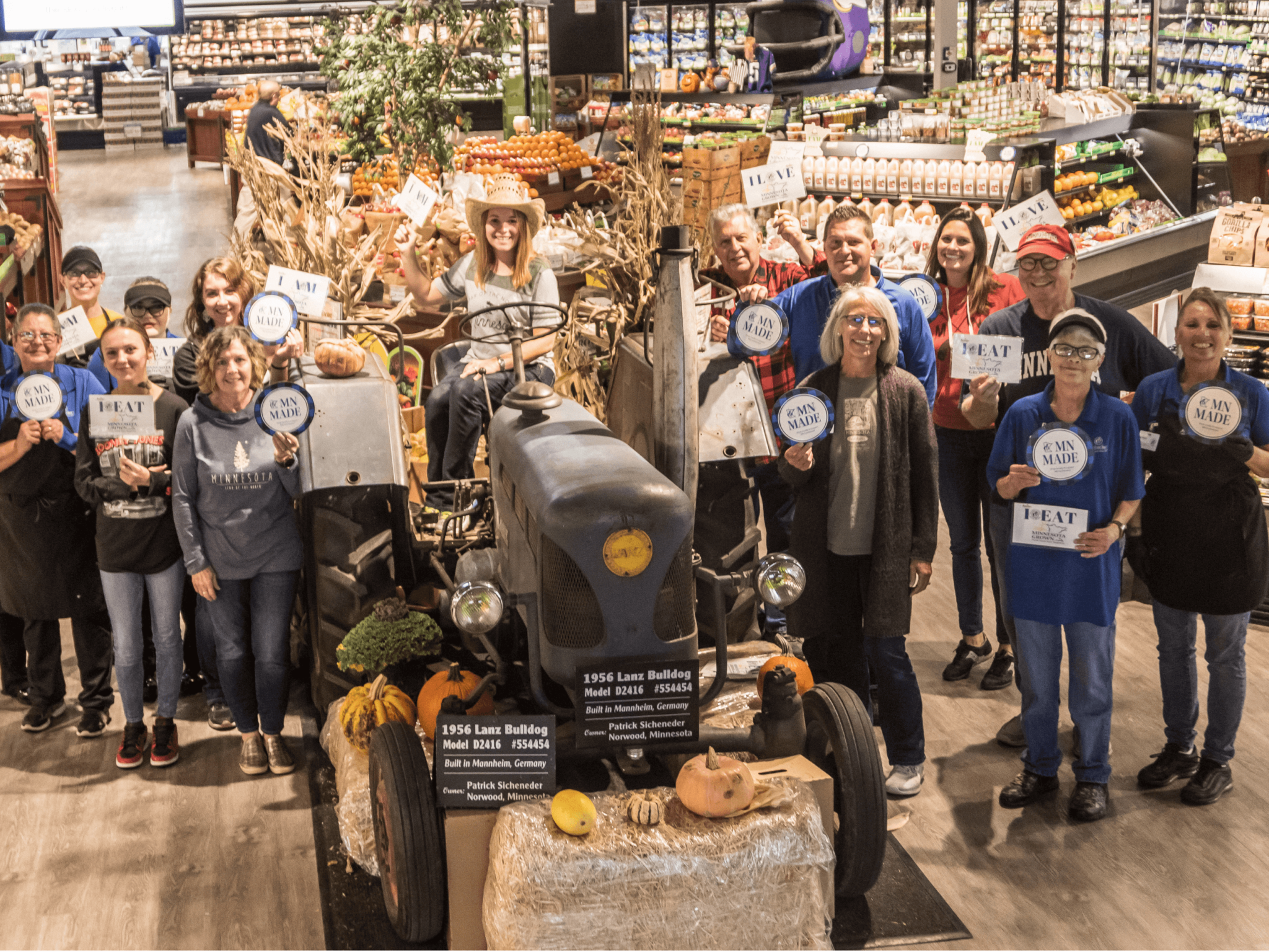 group photo of mackenthun's employees in front of the produce section that is decorated with MN Grown displays.