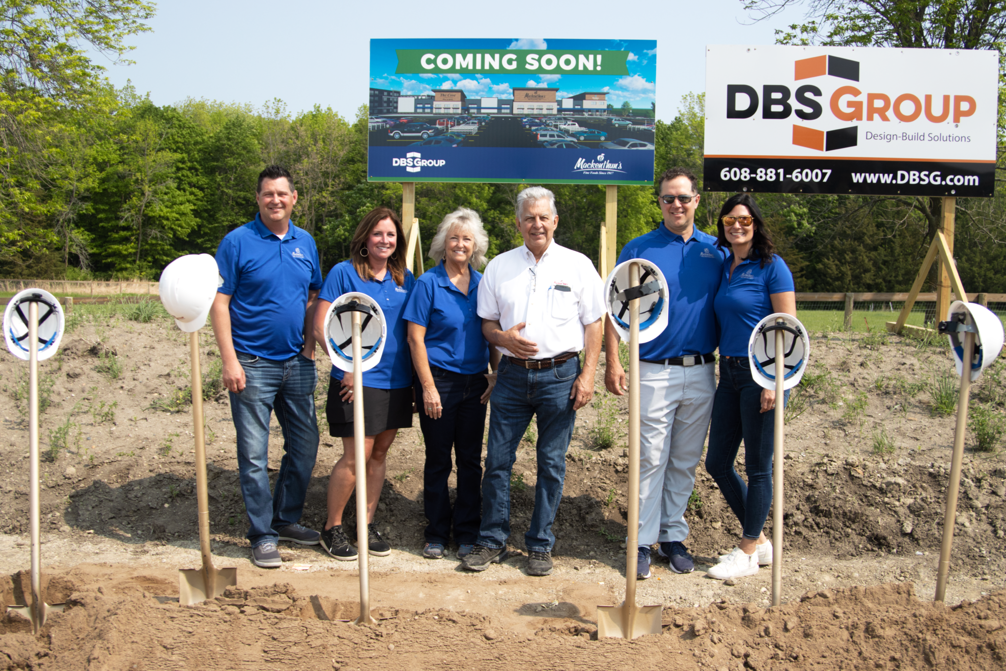 Mackenthun's family lined out in front of the Minnetrista Coming Soon construction sign.