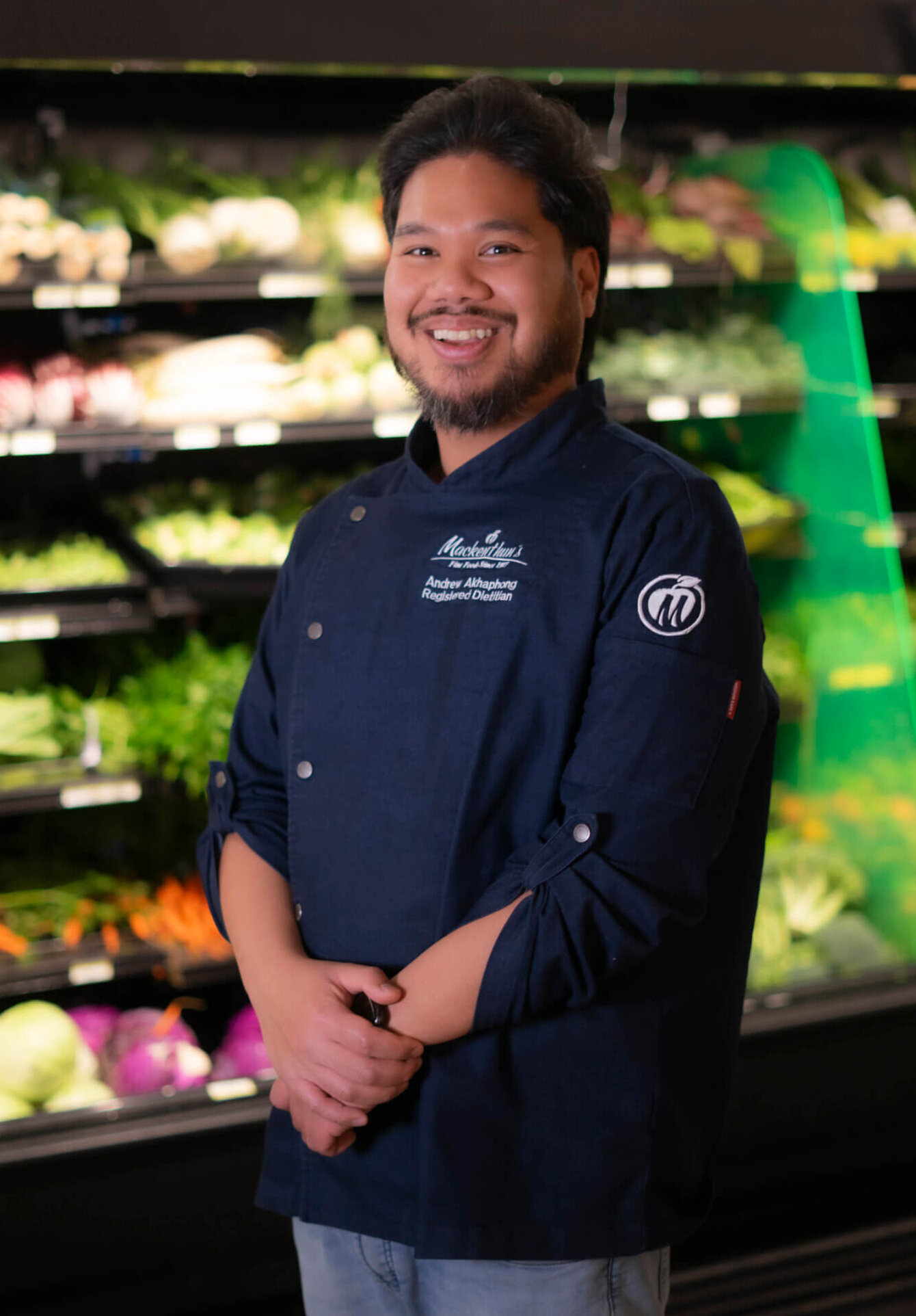 Andrew the dietitian is standing in front of produce.