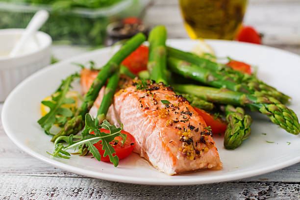 A meal featuring baked salmon. Image source: Elena_Danileiko | Getty Images/iStockphoto