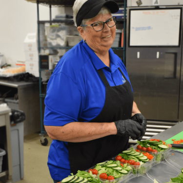 Carol making salads